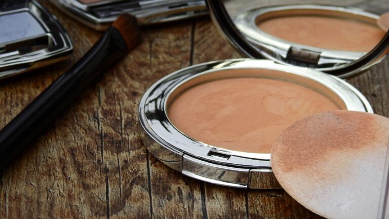 compact powder placed on a table with its foam used to conceal and set foundation