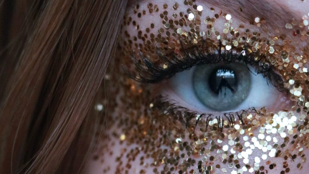 close up of a womans eye with glitter around her eyes as she has magnetic eyelashes