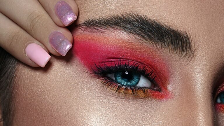 close up of a woman with blue eyes as she shows off her eye makeup with Masara and eyeshadow