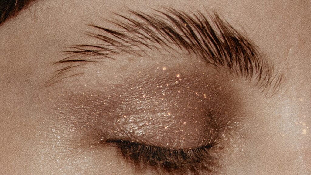 woman showing eye eyebrows and eyeshadow with minimal makeup