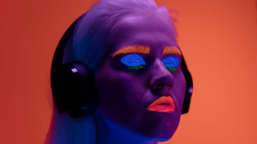 close up of a womans face with neon makeup