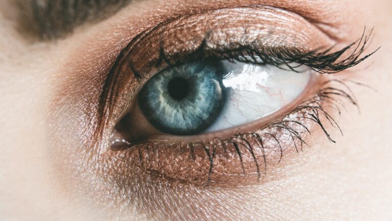 close up of womans blue eye as she has face scrum on