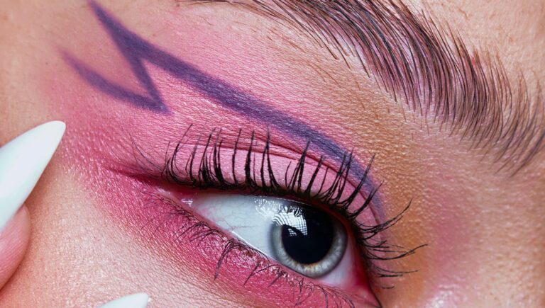 woman showing her eyeliner drawn with eyebrow pencil in purple color
