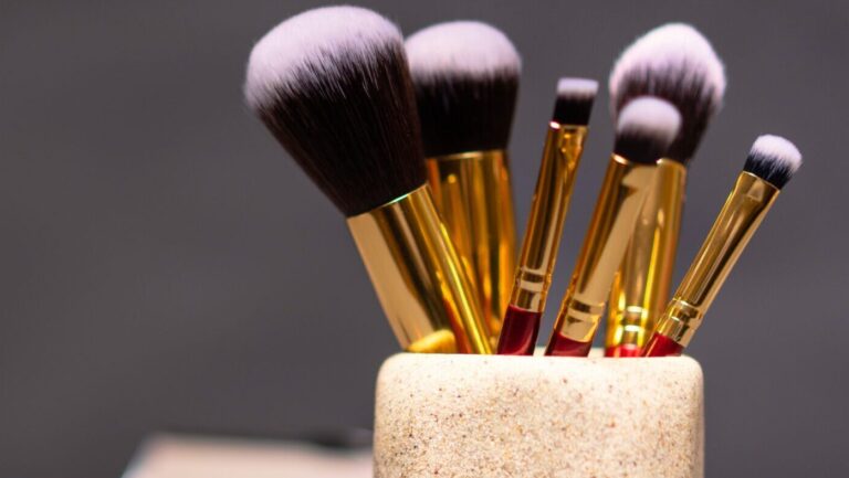 makeup brushes placed in a holder used for application of mica powder