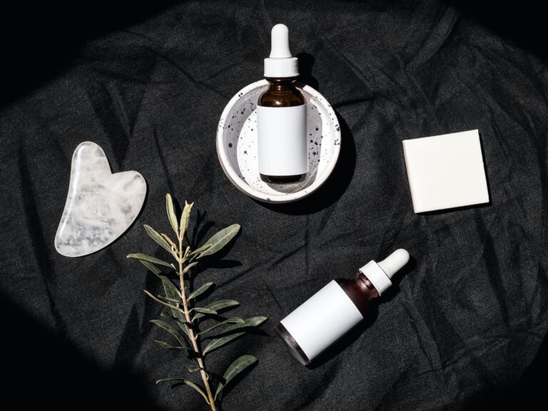 two white serum bottles placed on a black background.