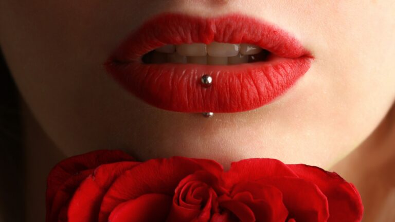 close up of a lip with red lip gloss and half cropped photo of a rose