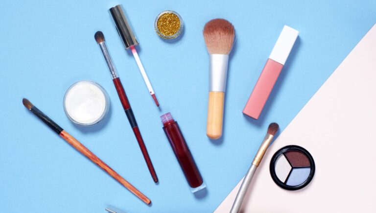makeup utensils all placed on a blue background