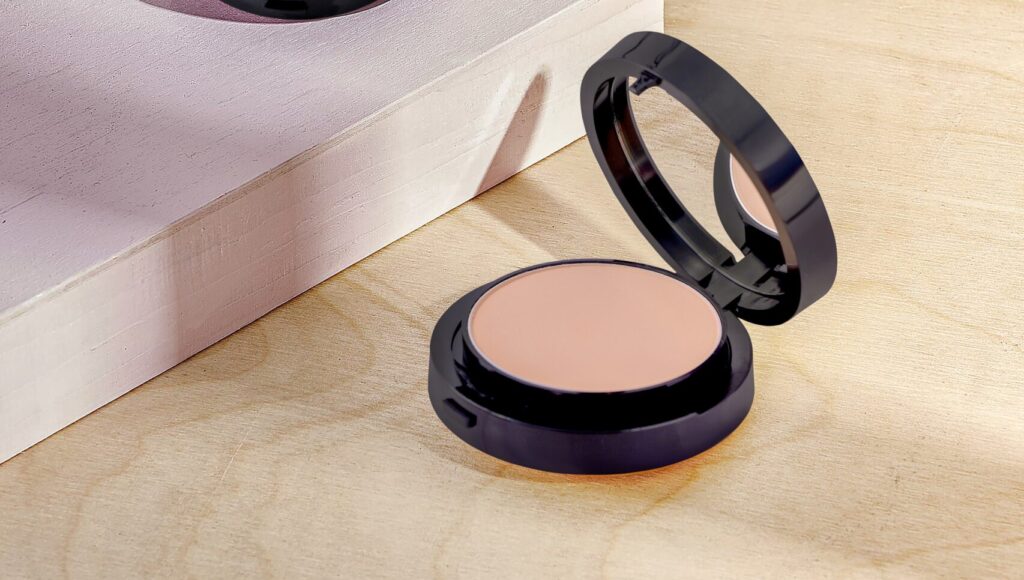 two mineral-based face powders placed on a table and a white rectangle box placed besides it.