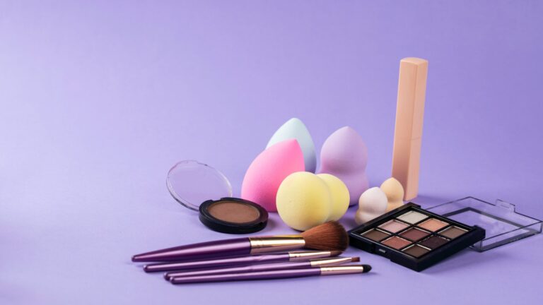 beauty blenders, brushes, makeup kits; all placed on a purple background.