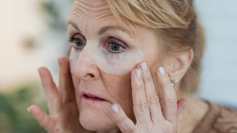 an old woman after applying anti-aging face serum on her face which she made at home