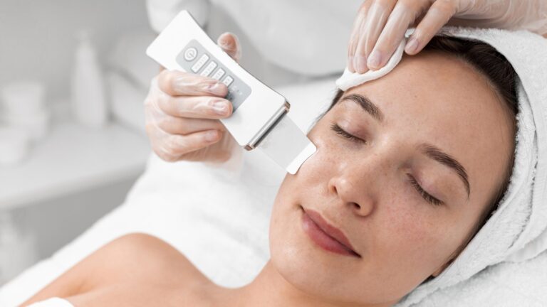 a woman getting a hydrafacial treatment on her as she lies down on a bed