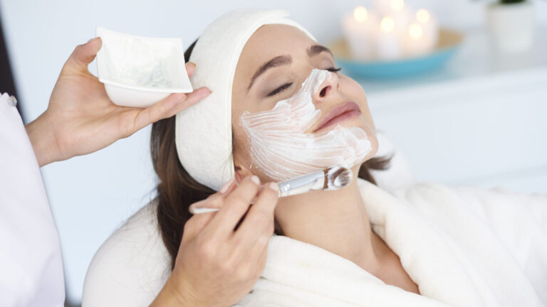 a woman getting mask applied on her face as a part of HydraFacial