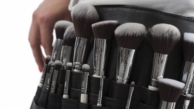 makeup brushes all placed in a makeup brush carrier attached to persons waist.