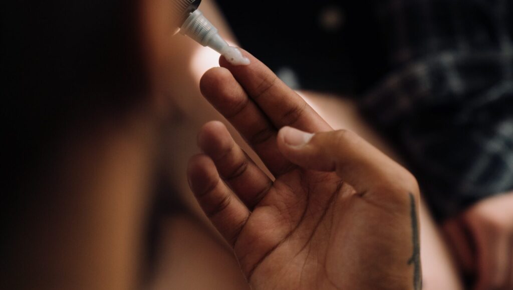 woman applying tinted CC cream on her hand