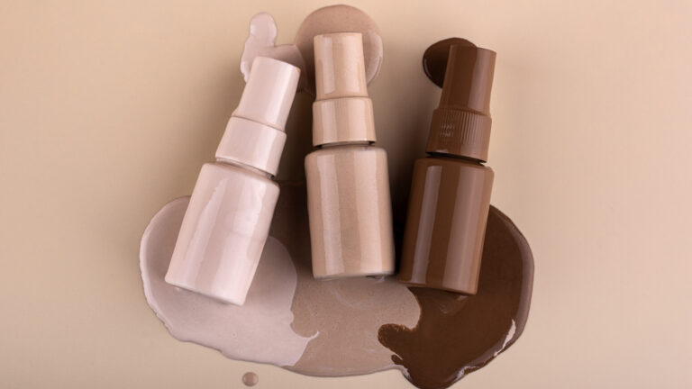 three different shades of mineral based CC creams placed on each of their Containments on a skin background