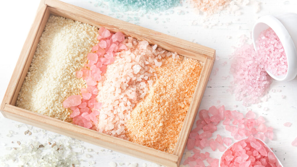 Multicolored sea tree hut face scrub in a box on a white background top view, flat lay.