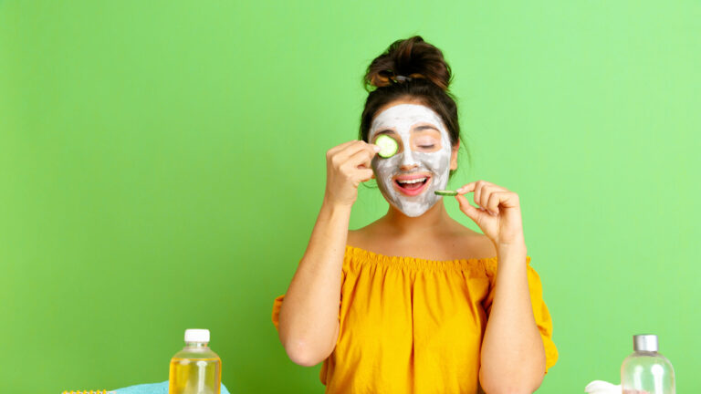 Portrait of young caucasian woman in her beauty day, skin and hair care routine. Female model with natural cosmetics applying chemical body scrub. Body and face care, natural beauty concept.