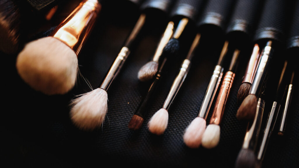 Set of makeup brushes lies on the table.